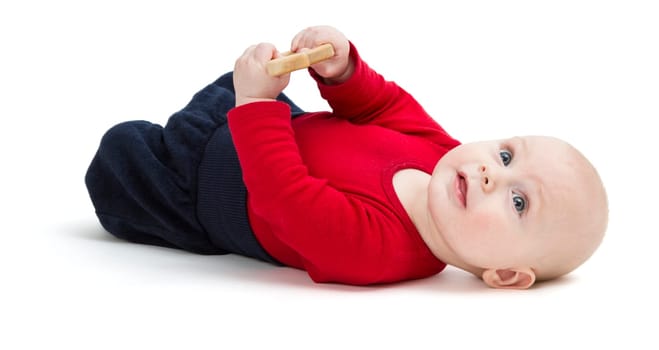 happy baby in red shirt on floor. isolated on white background. studio shot