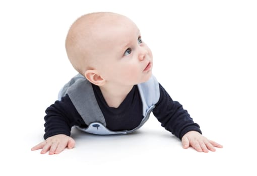 baby on flor in blue clothing looking to side