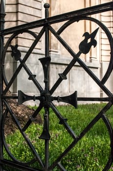 Detail of old black ornamental iron fence closeup