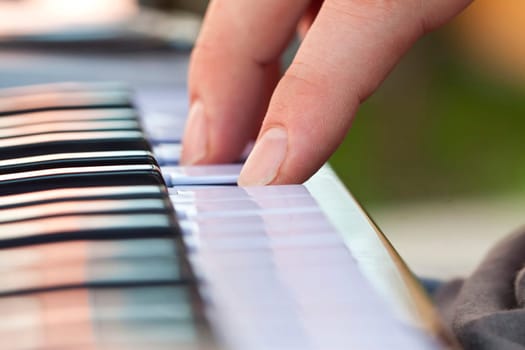 Close-up of hand playing the electric organ