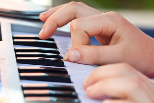 Close-up of hand playing the electric organ