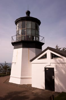 A footpath leads down to the lighthouse on a sunny day