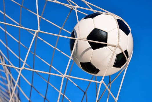 Football flies into goal in clear blue skies