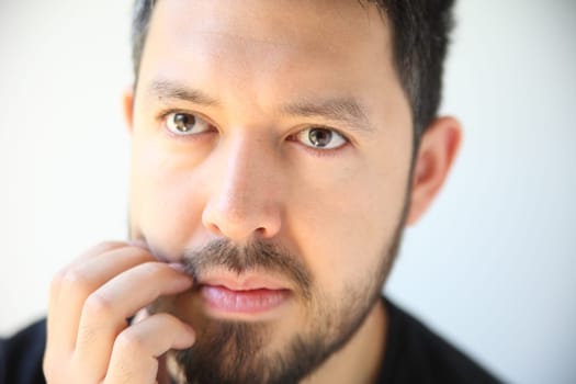 thirty-something man has an irritation in his beard