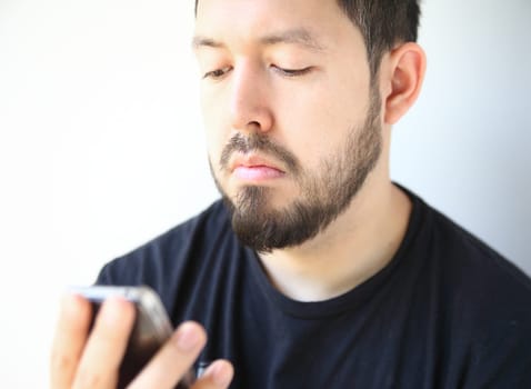 man looking down at his smartphone