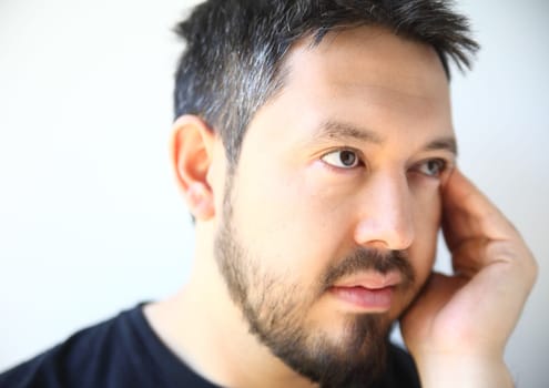 bearded thirty-something man with a pensive expression