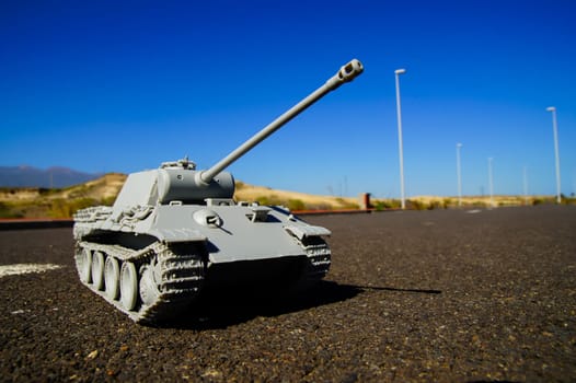 Modern War Concept Model Tank in the Middle of an Asphalt Road