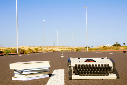 On the Road Writing Concept Typewriter over an Asphalt Street