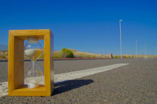 Time Concept Hourglass on the Asphalt Street