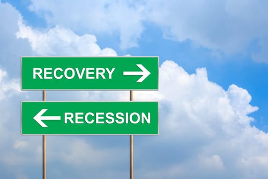 recovery and recession on green road sign with blue sky