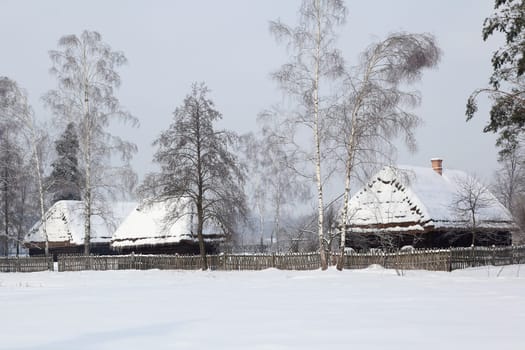Old hauses with snow on the roof.