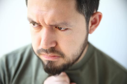 young man with heartburn feels nausea and other heartburn symptoms