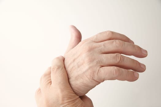 senior man holds his aching hand