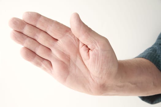 older man holding a hand out at an angle