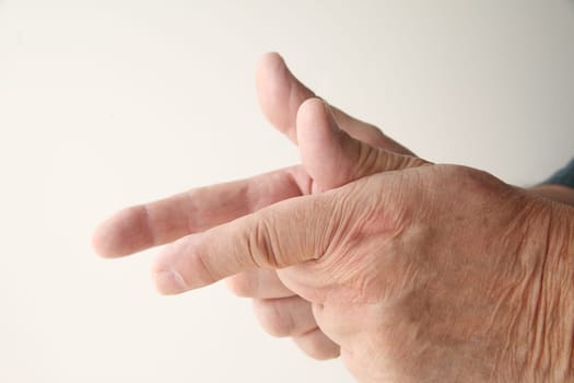 man pretends to shoot guns using his fingers