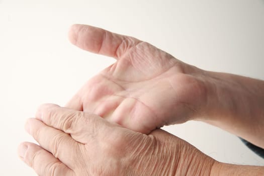 a man flexes one hand backward with the other
