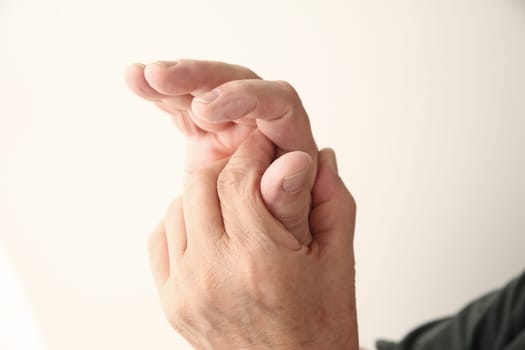 older man with a sore finger