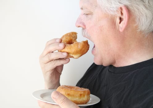 senior man enjoying unhealthy food