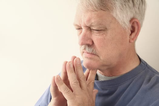 senior man is lost in thought