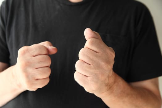 senior man displaying a hostile or aggressive gesture