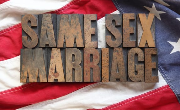 the words 'same sex marriage' on an old USA flag