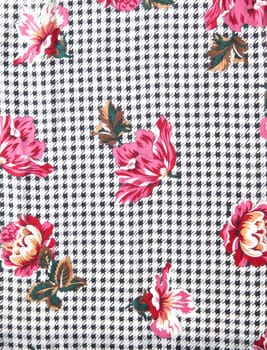 decorative flowers on a black and gray pattern background