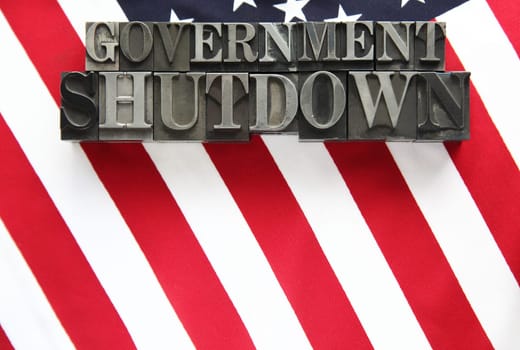 the words government shutdown on an American flag