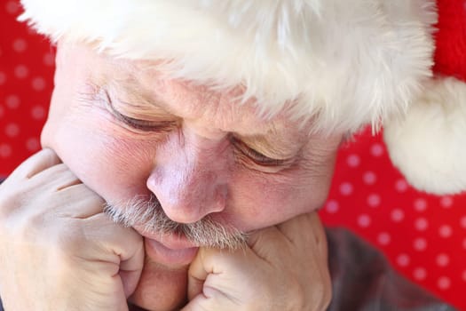 unhappy older man with hands against cheeks