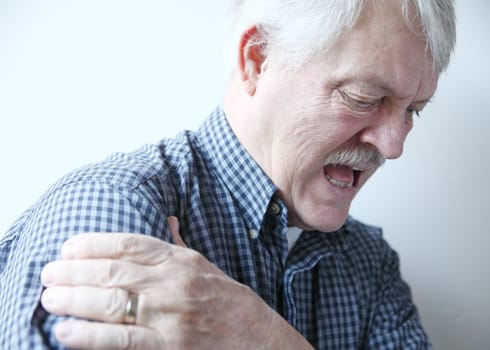 older man with pain in his shoulder