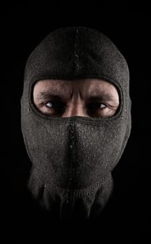 Masked man on a dark background