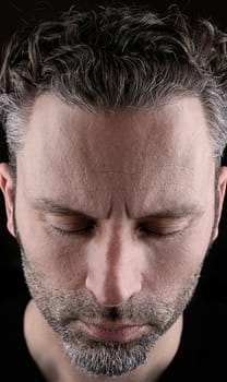 Thinking man with closed eyes