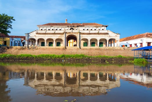 Old abandoned market in Mompox, Colombia reflected in the Magdalena River