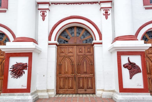 Facade of the church on the main town plaza in the town of Guatape in Antioquia, Colombia