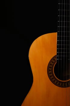 Acoustic guitar on a black background