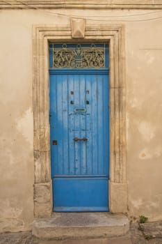 Old blue wooden entrance door to the house. Mediterranean architecture.