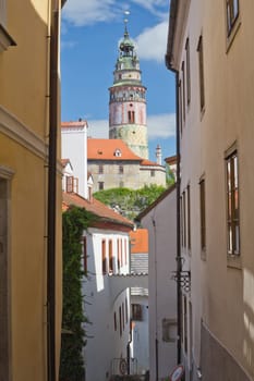 The narrow street in the historic center of the city with a vista view of the famous castle (Cesky Krumlov, Czech Republic)