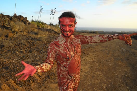 Latin American Man with Long Hairs Masked as a Devil in the Desert