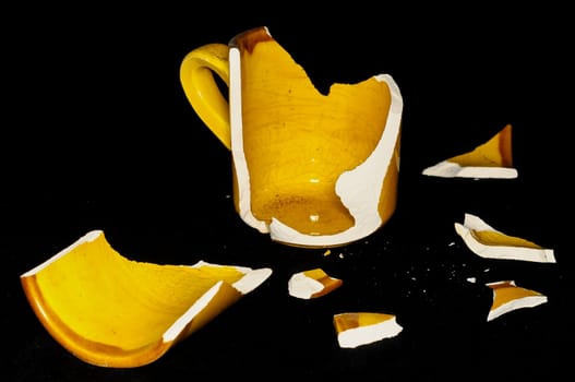 Broken Orange Coffee Cup on A Black Bacground
