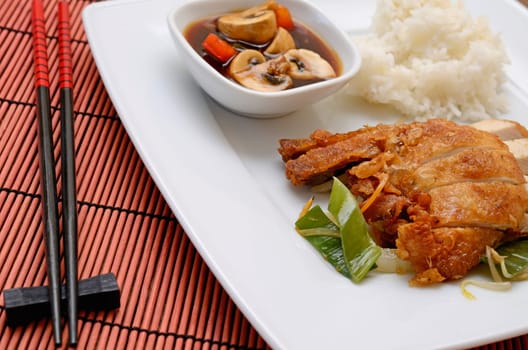 Asian fried chicken with rice and paprika mushrooms souce