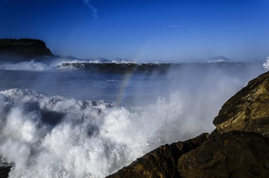 Beautiful splashing wave in to the rocks, with great details and quality. The image is takken in Spain, Getaria city at the Atlantic ocean.