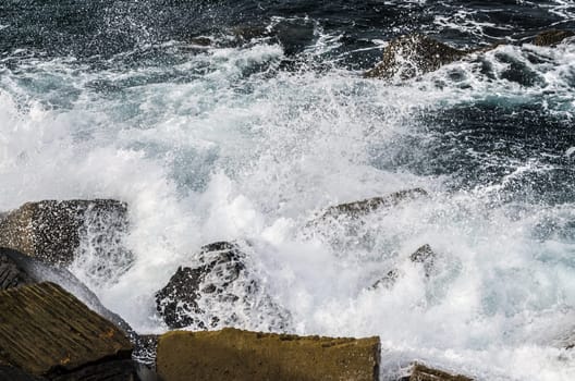 Beautiful splashing wave in to the rocks, with great details and quality. The image is takken in Spain, Getaria city at the Atlantic ocean.