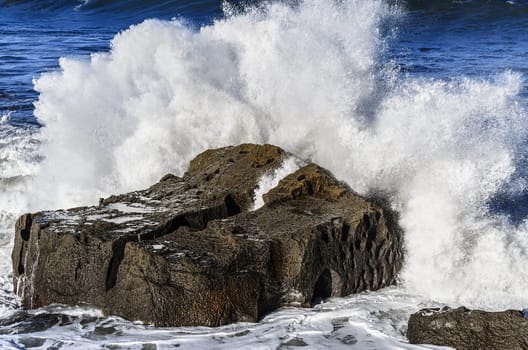 Beautiful splashing wave in to the rocks, with great details and quality. The image is takken in Spain, Getaria city at the Atlantic ocean.