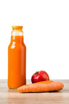 Bottle with carrots juice and an apple, it is isolated on white