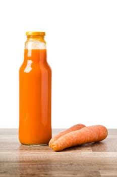 Bottle with carrots juice, it is isolated on white