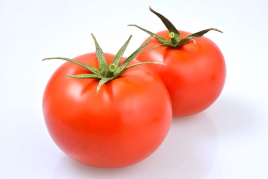 red and ripe tomatoes on a white background