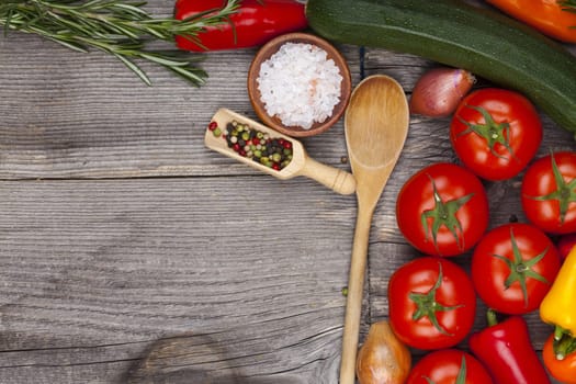 Rustic wooden board with vegetables and zuaten