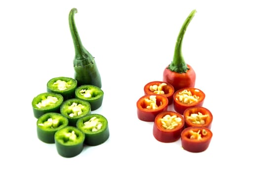 red and green hot chili pepper slices on a white background
