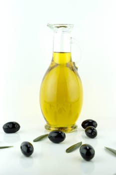 olives and a bottle of olive oil with olive leaves.