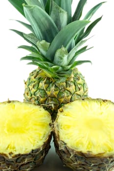 Ripe pineapple with slices isolated on white background