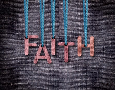 Faith Letters hanging strings with blue sackcloth background.